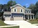 Beautiful two-story home with a three-car garage, complemented by lush landscaping at 9945 Cask Way, Huntersville, NC 28078