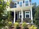 Inviting front porch adorned with stone accents and elegant white columns at 9945 Cask Way, Huntersville, NC 28078