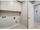 Practical laundry room with ample cabinet storage, utility connections, and easy access door at 9945 Cask Way, Huntersville, NC 28078