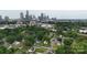 Panoramic aerial view of the city skyline with mature trees and residential neighborhood below at 1004 Johnson St, Charlotte, NC 28206