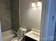 Modern bathroom featuring gray tiled shower, contemporary vanity, and updated fixtures at 1004 Johnson St, Charlotte, NC 28206