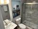 Modern bathroom featuring a glass-enclosed shower, neutral stone tile and elegant fixtures at 1004 Johnson St, Charlotte, NC 28206