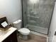 Sleek bathroom with walk-in shower, updated vanity, and wood-look flooring at 1004 Johnson St, Charlotte, NC 28206