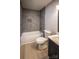 Modern bathroom featuring a tiled shower-tub combo, gray tile, and a stylish vanity with storage at 1004 Johnson St, Charlotte, NC 28206