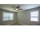 This bedroom features two windows with blinds, a ceiling fan, and wood-look flooring at 1004 Johnson St, Charlotte, NC 28206