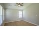 Bright bedroom with neutral walls, wood-look floors, ceiling fan, and two windows offering lots of natural light at 1004 Johnson St, Charlotte, NC 28206