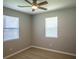 This bedroom features two windows with blinds, a ceiling fan, and wood-look flooring at 1004 Johnson St, Charlotte, NC 28206