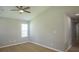 Bright bedroom with neutral walls, wood-look floors, ceiling fan, and a view into the hallway at 1004 Johnson St, Charlotte, NC 28206