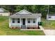 Charming single-story home with a welcoming front porch and well-maintained lawn and landscaping at 1004 Johnson St, Charlotte, NC 28206