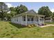 Charming single-story home with a welcoming front porch, landscaped yard, and blue siding at 1004 Johnson St, Charlotte, NC 28206