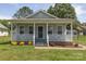 Charming single-story home with a welcoming front porch, well-maintained lawn, and inviting curb appeal at 1004 Johnson St, Charlotte, NC 28206