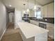 Modern kitchen featuring white cabinets, stainless steel appliances, a large island, and pendant lighting at 1004 Johnson St, Charlotte, NC 28206