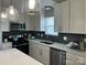 A well-lit kitchen featuring stainless steel appliances and modern cabinetry at 1004 Johnson St, Charlotte, NC 28206
