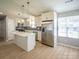 Well-lit open kitchen with stainless steel appliances, center island, and eat-in area at 1004 Johnson St, Charlotte, NC 28206