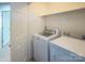 Convenient laundry room with modern appliances, including a washer and dryer, and ample shelving at 1004 Johnson St, Charlotte, NC 28206