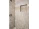Close-up of a tiled shower featuring a built-in niche and sleek showerhead for a modern touch at 1004 Johnson St, Charlotte, NC 28206