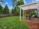 Relaxing backyard featuring a patio with pergola covering and a grassy area at 1014 Harrogate Ln, Matthews, NC 28104