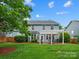 Beautiful backyard featuring a pergola, patio seating, and lush green lawn, perfect for outdoor entertaining at 1014 Harrogate Ln, Matthews, NC 28104