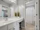Bright bathroom with white vanity, large mirror, and separate shower area at 1014 Harrogate Ln, Matthews, NC 28104