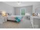 Colorful bedroom with queen bed, desk, and dresser at 1014 Harrogate Ln, Matthews, NC 28104