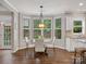Bright breakfast nook with bay window and backyard view adjacent to the kitchen area at 1014 Harrogate Ln, Matthews, NC 28104