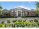 Exterior shot of elegant brick clubhouse with manicured landscaping and prominent entrance at 1014 Harrogate Ln, Matthews, NC 28104