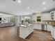 Bright kitchen with a center island, stainless appliances, white cabinets, and an open-concept layout at 1014 Harrogate Ln, Matthews, NC 28104