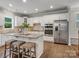Bright kitchen featuring stainless appliances, white cabinetry, granite countertops, and a center island at 1014 Harrogate Ln, Matthews, NC 28104