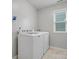 Functional laundry room with washer, dryer, and natural light at 1014 Harrogate Ln, Matthews, NC 28104