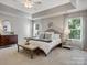 Bright main bedroom featuring a tray ceiling, ceiling fan, and dual windows at 1014 Harrogate Ln, Matthews, NC 28104
