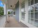 Charming porch features wood siding, white columns, and an entry door at 1014 Harrogate Ln, Matthews, NC 28104