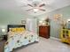 This cozy bedroom includes sunflower bedding, soft carpet, and plenty of sunlight at 10545 Mount Holly Huntersville Rd, Huntersville, NC 28078