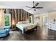 Spacious bedroom with wood floors, decorative wall art, and lots of natural light at 10545 Mount Holly Huntersville Rd, Huntersville, NC 28078