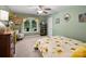 Cozy bedroom features sunflower bedding, and a large window with curtains at 10545 Mount Holly Huntersville Rd, Huntersville, NC 28078