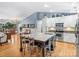 Kitchen featuring white cabinets, stainless appliances, granite counters, hardwood floors, and a view of the living spaces at 10545 Mount Holly Huntersville Rd, Huntersville, NC 28078