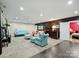 Comfortable living room featuring gray carpeting, brown accent wall, and access to the bedroom at 10545 Mount Holly Huntersville Rd, Huntersville, NC 28078
