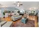 Bright open-concept living room flowing into the kitchen and dining areas, featuring hardwood floors at 10545 Mount Holly Huntersville Rd, Huntersville, NC 28078