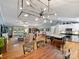 Open concept living room with a kitchen island, spacious seating, hardwood flooring, and lots of natural light at 10545 Mount Holly Huntersville Rd, Huntersville, NC 28078
