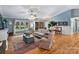 Open living area with hardwood floors, comfortable seating, and a view of the entry foyer at 10545 Mount Holly Huntersville Rd, Huntersville, NC 28078