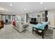 Spacious living room with a gray couch, blue futon, TV, and access to the outdoors at 10545 Mount Holly Huntersville Rd, Huntersville, NC 28078