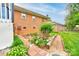 Well-maintained garden with brick-paved walkway bordering the home's backyard at 109 Ashley St, Shelby, NC 28150