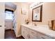 Cozy bathroom with wood-look flooring, white vanity, and shower-tub combo at 109 Ashley St, Shelby, NC 28150