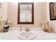 Neutral-toned full bathroom with decorative mirror and modern faucet at 109 Ashley St, Shelby, NC 28150