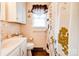 Full bathroom with floral shower curtain, wood-look floor, and pink tile walls at 109 Ashley St, Shelby, NC 28150