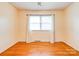 Bedroom showcasing hardwood floors, natural light from a window, and freshly painted walls at 109 Ashley St, Shelby, NC 28150