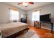 Cozy bedroom showcasing a comfortable bed, natural light from windows, and hardwood flooring at 109 Ashley St, Shelby, NC 28150