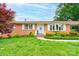 Charming brick home with well-manicured lawn, flowering bushes, and a welcoming front porch at 109 Ashley St, Shelby, NC 28150