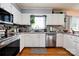Modern kitchen featuring stainless steel appliances, a tiled backsplash, and ample counter space for meal preparation at 109 Ashley St, Shelby, NC 28150