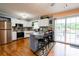 Open kitchen with a breakfast bar, stainless steel appliances, and access to a deck through sliding glass doors at 109 Ashley St, Shelby, NC 28150
