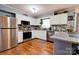 Contemporary kitchen with stainless steel appliances, granite countertops, and ample cabinet space at 109 Ashley St, Shelby, NC 28150